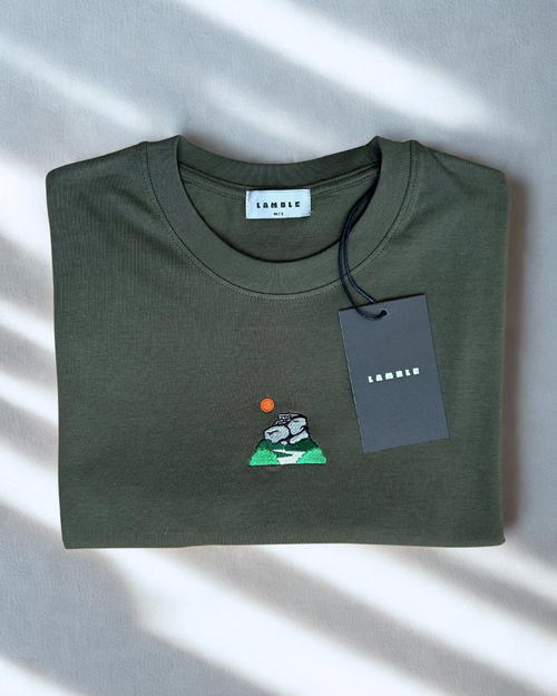 Peak District T-shirt folded with embroidered artwork of gritstone edges and hanging tag.