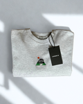 Peak District Sweatshirt in grey displayed folded with embroidered gritstone edge and sun artwork and a tag. 