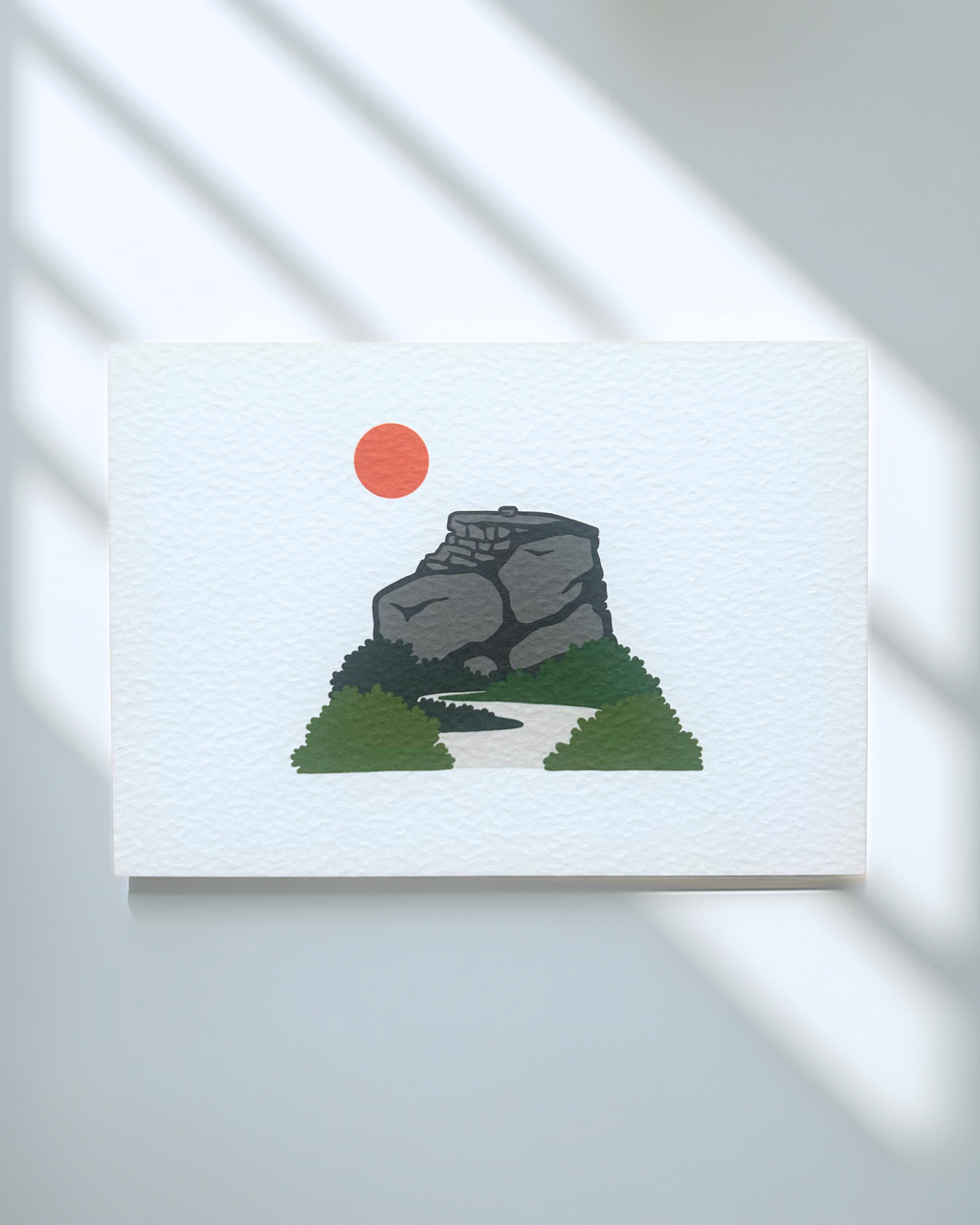 Peak District Art Print featuring a gritstone rock formation and a sun, printed on textured card.