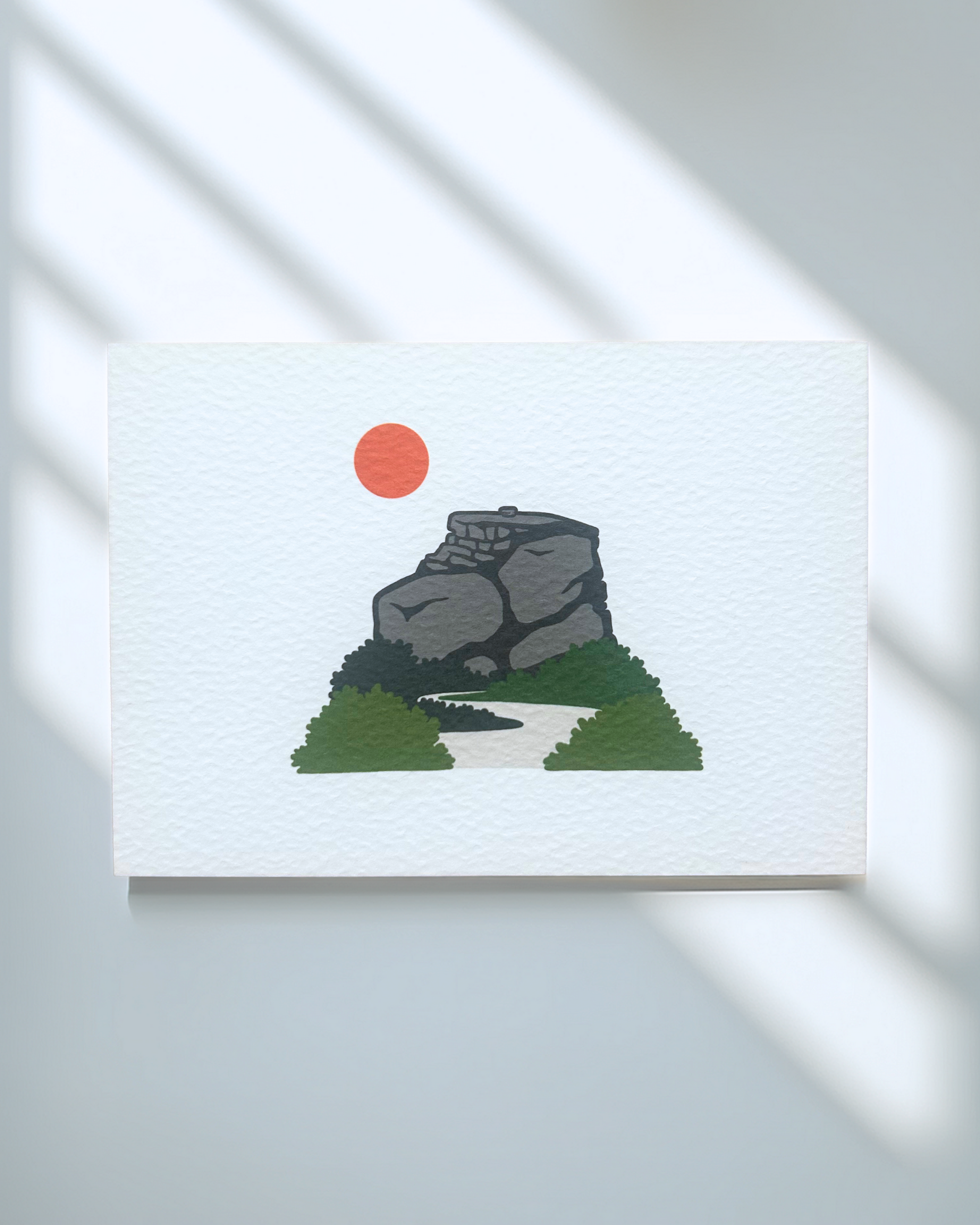 Peak District Art Print featuring a gritstone rock formation and a sun, printed on textured card.
