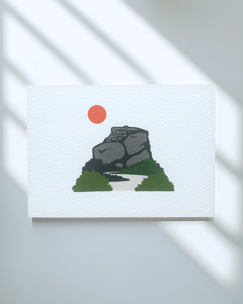 Peak District Art Print featuring a gritstone rock formation and a sun, printed on textured card.