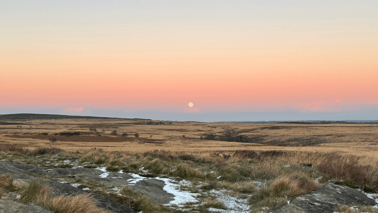 Moorland landscape with a moon rising over the hills in the Peak District