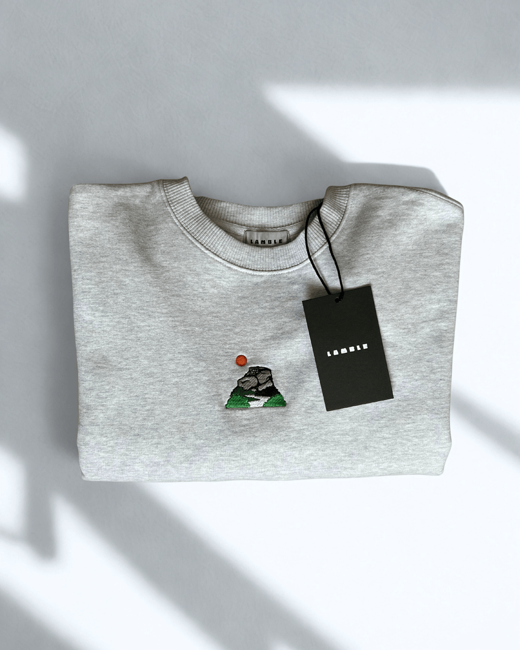 Peak District Sweatshirt folded with embroidered artwork of gritstone edges and hanging tag