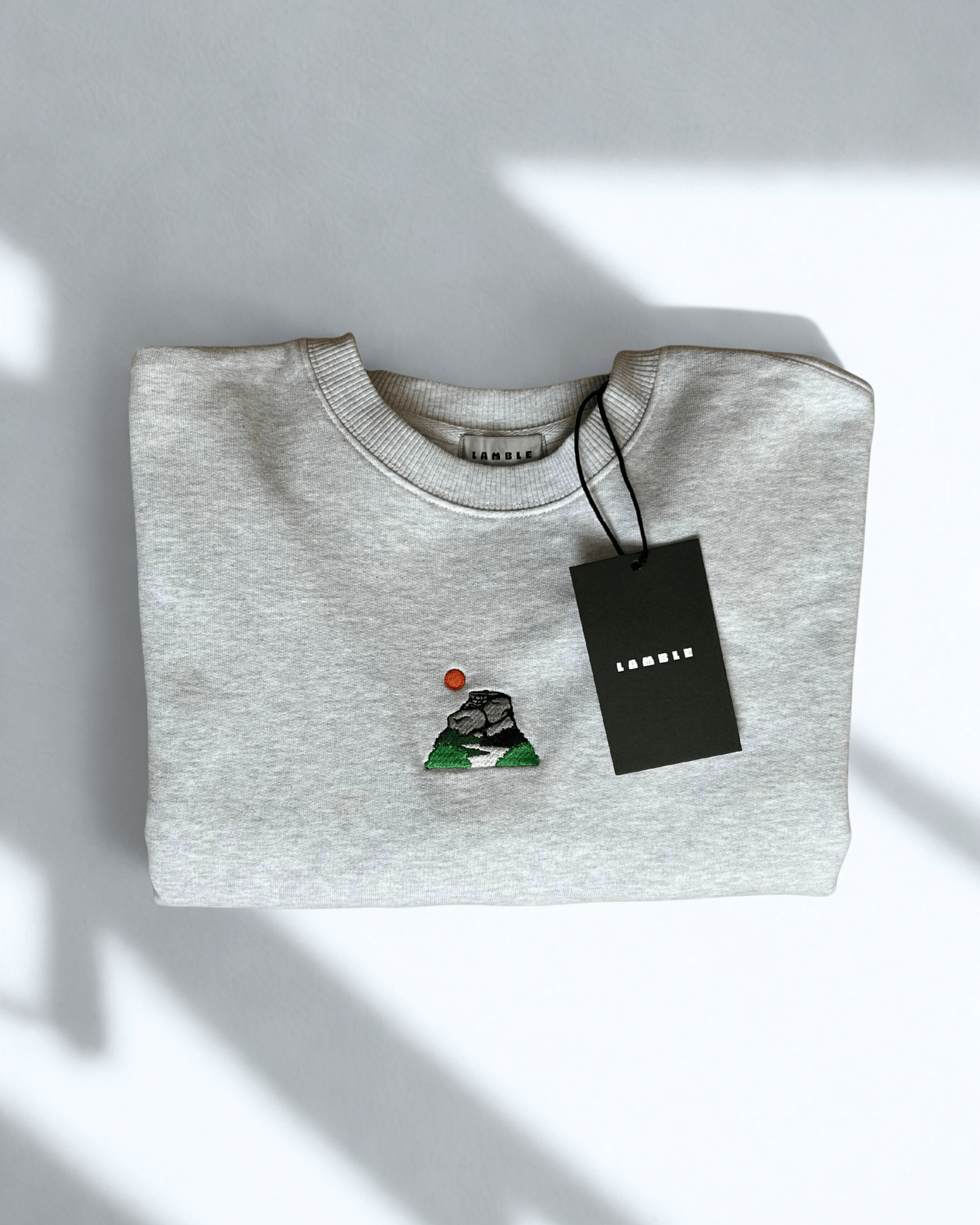 Peak District Sweatshirt folded with embroidered artwork of gritstone edges and hanging tag